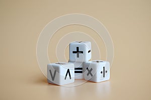FourÃÂ diceÃÂ withÃÂ arithmeticÃÂ operationÃÂ symbolsÃÂ onÃÂ softÃÂ orangeÃÂ background. Miniature and business concept.
